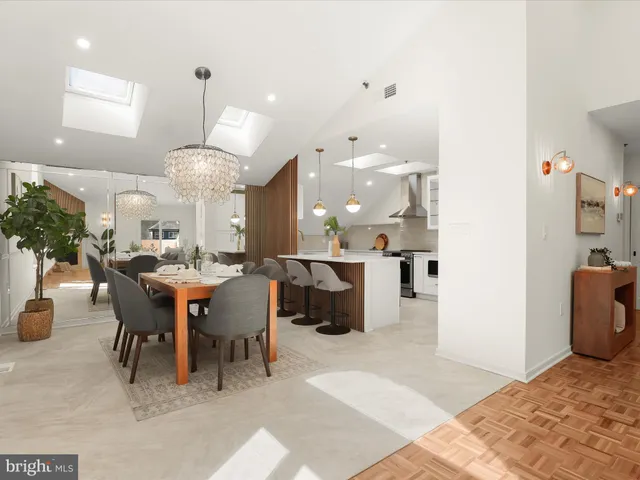 a large kitchen with a table and chairs