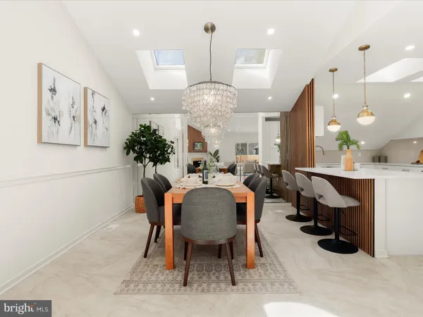 a large kitchen with a table and chairs