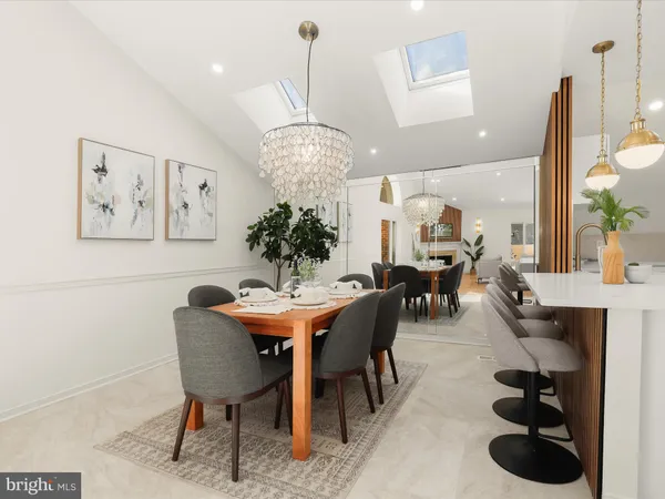 a view of a dining room with furniture and chandelier