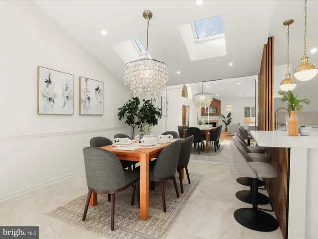 a view of a dining room with furniture and chandelier