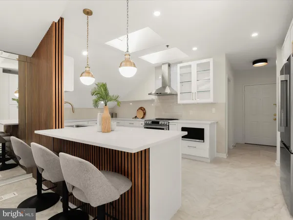 a kitchen with a table chairs stove and microwave