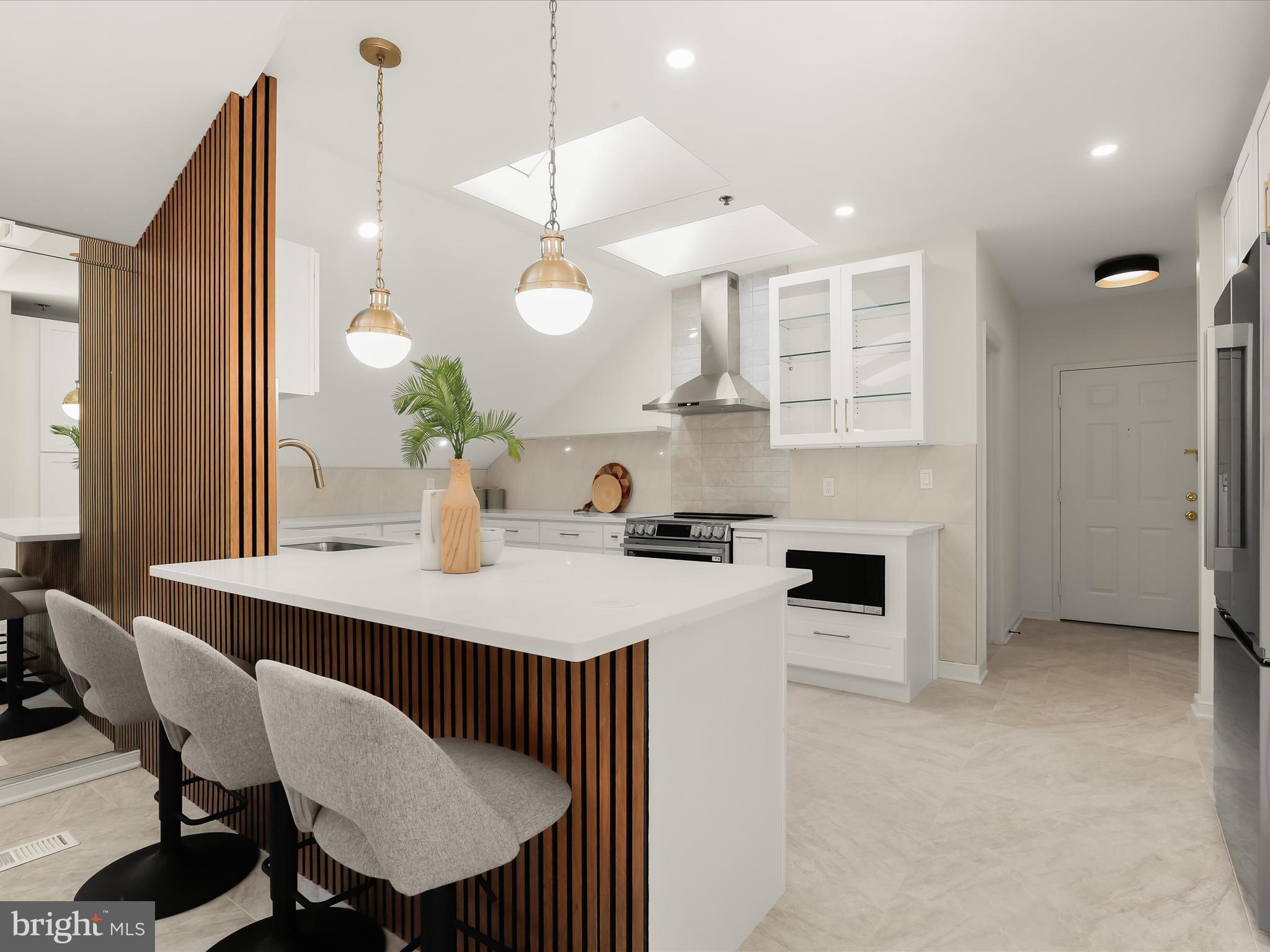 2331 Old Court Road, Unit 506 Pikesville, MD 21208 - Photo 15 of 51 a kitchen with a table chairs stove and microwave