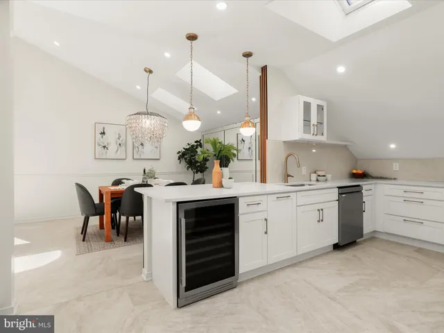 a large kitchen with a large counter space and stainless steel appliances