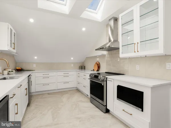 a kitchen with granite countertop white cabinets and white appliances