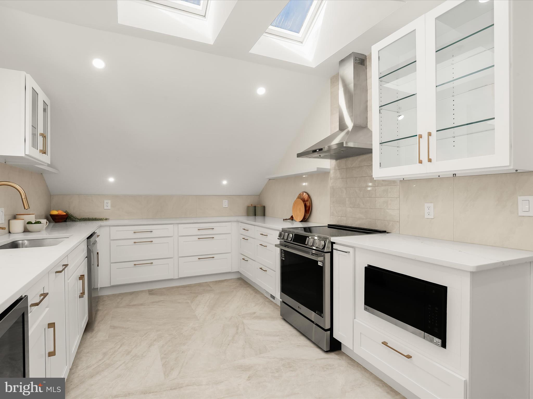 2331 Old Court Road, Unit 506 Pikesville, MD 21208 - Photo 17 of 51 a kitchen with granite countertop white cabinets and white appliances
