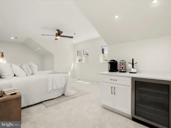 a living room with furniture a chandelier and a window