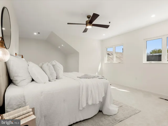 a large white bed in a white room
