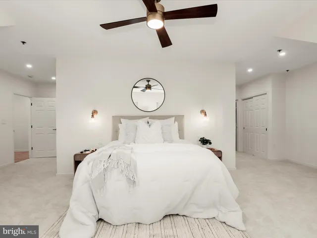 a bedroom with a large bed and a chandelier