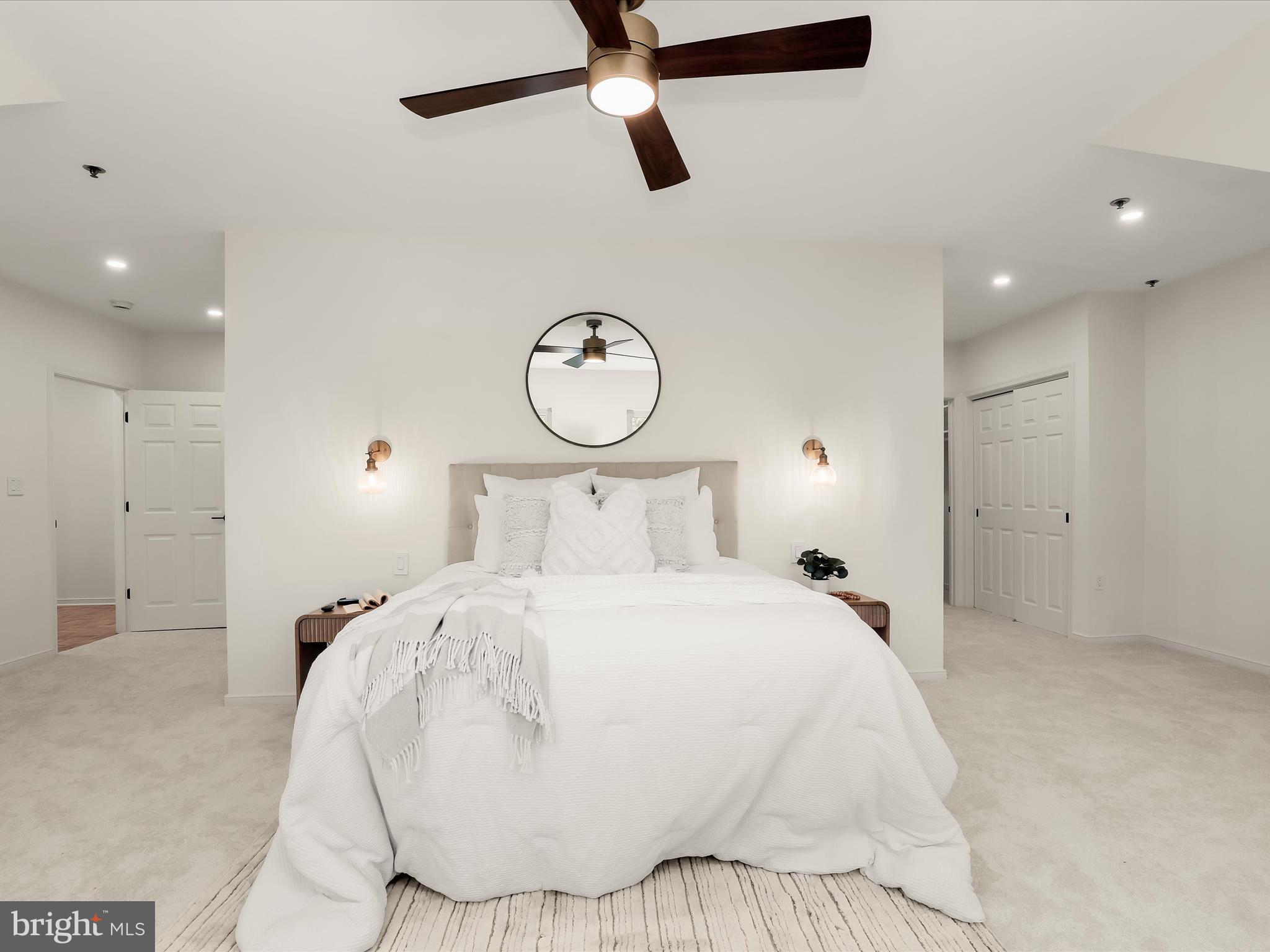 2331 Old Court Road, Unit 506 Pikesville, MD 21208 - Photo 24 of 51 a bedroom with a large bed and a chandelier