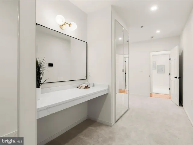 a bathroom with a double vanity sink mirror and shower