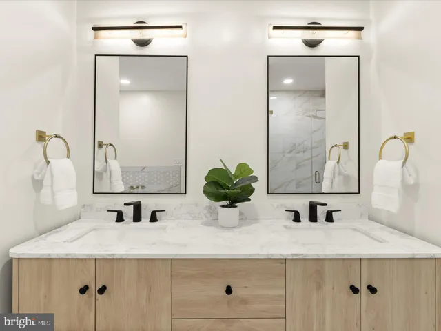 a bathroom with double sink and a mirror