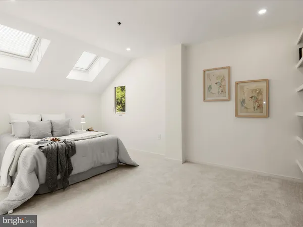 a room with two bed and painting on the wall