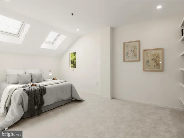 a room with two bed and painting on the wall