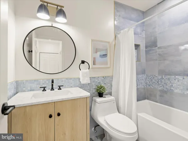 a bathroom with a sink a mirror a toilet and a mirror