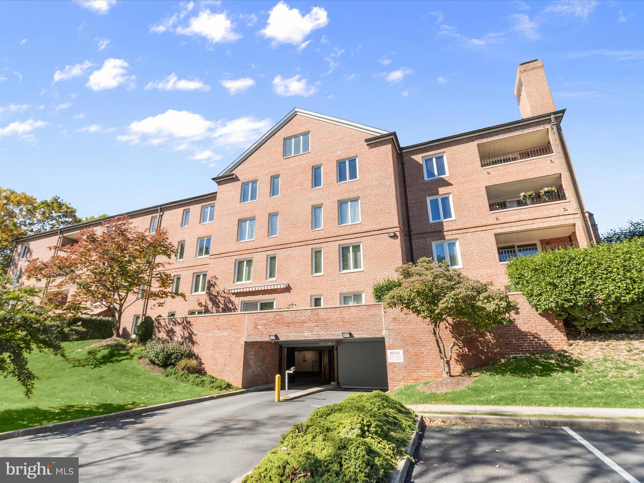 2331 Old Court Road, Unit 506 Pikesville, MD 21208 - Photo 38 of 51 a front view of a building with a garden