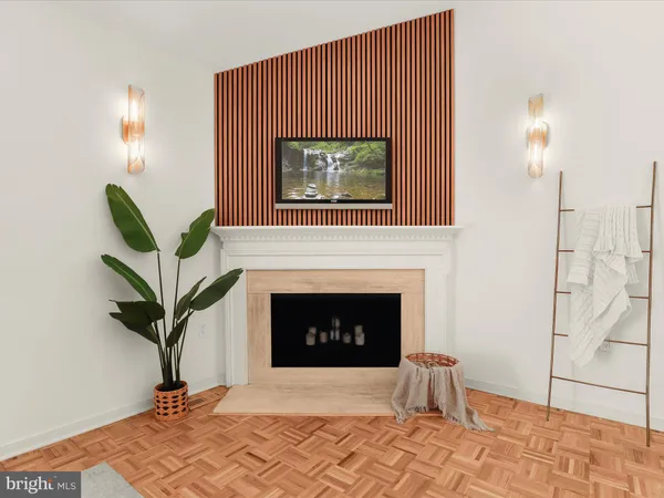a living room with a fireplace windows and a potted plant