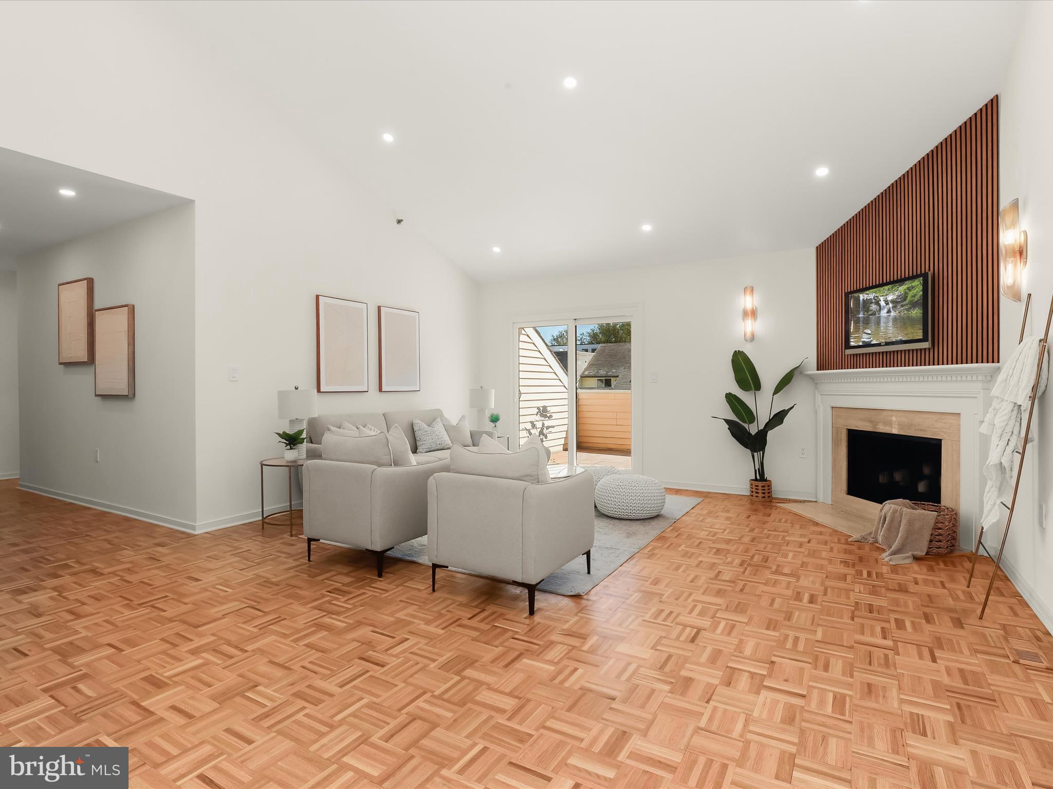 2331 Old Court Road, Unit 506 Pikesville, MD 21208 - Photo 8 of 51 a living room with furniture a fireplace and a flat screen tv