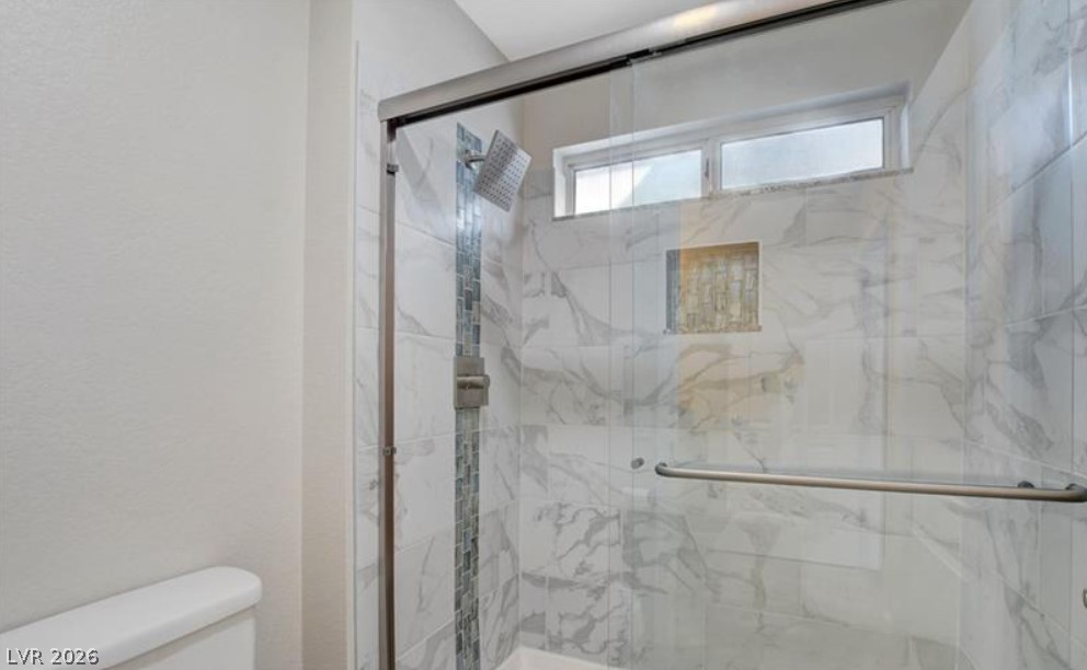2716 Showcase Drive Las Vegas, NV 89134 - Photo 24 of 45 A well-lit shower features contemporary tile work and a convenient built-in niche.