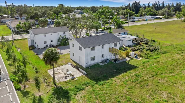 an aerial view of a house with a garden and lake view