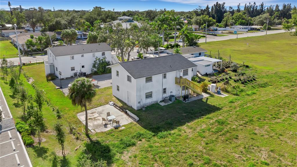 an aerial view of a house with a garden and lake view