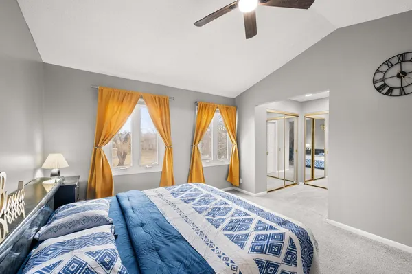 a bedroom with a bed and a large window