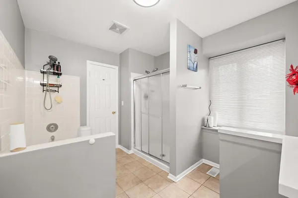 a bathroom with a shower and a glass door