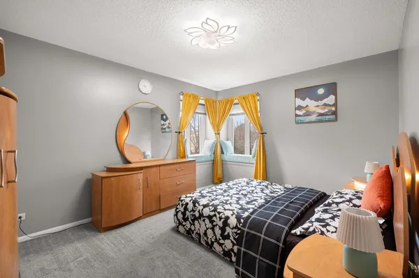 a bedroom with a bed and dresser