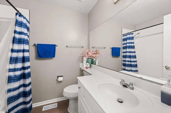 a bathroom with a sink and mirror with toilet