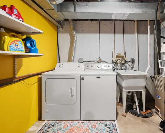 a utility room with a sink a washer and dryer