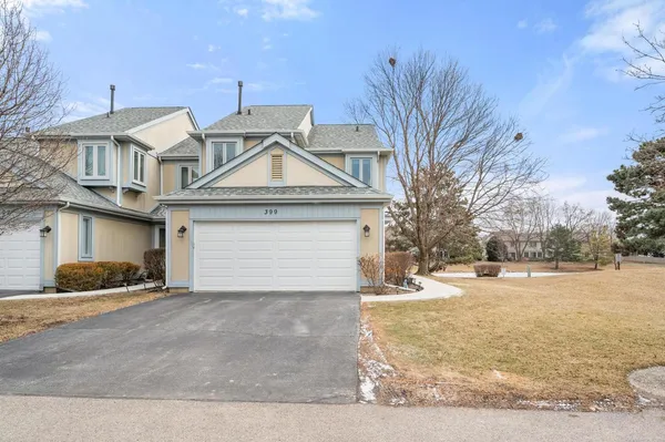 a front view of a house with a yard and garage