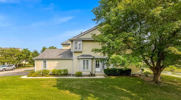 a front view of a house with a garden and yard