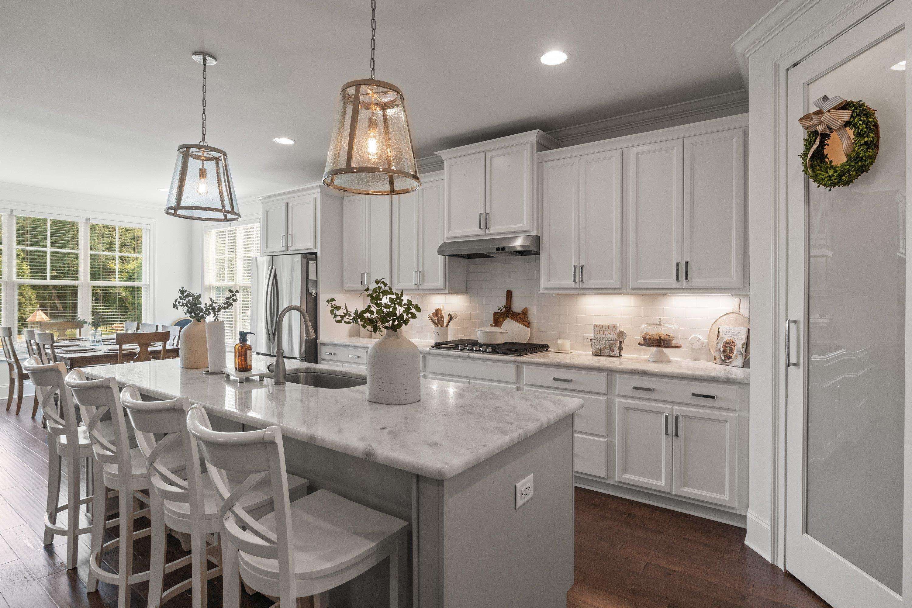 4136 Olde Judd Drive Willow Spring, NC 27592 - Photo 11 of 47 a kitchen with stainless steel appliances granite countertop a sink a stove and a wooden floors