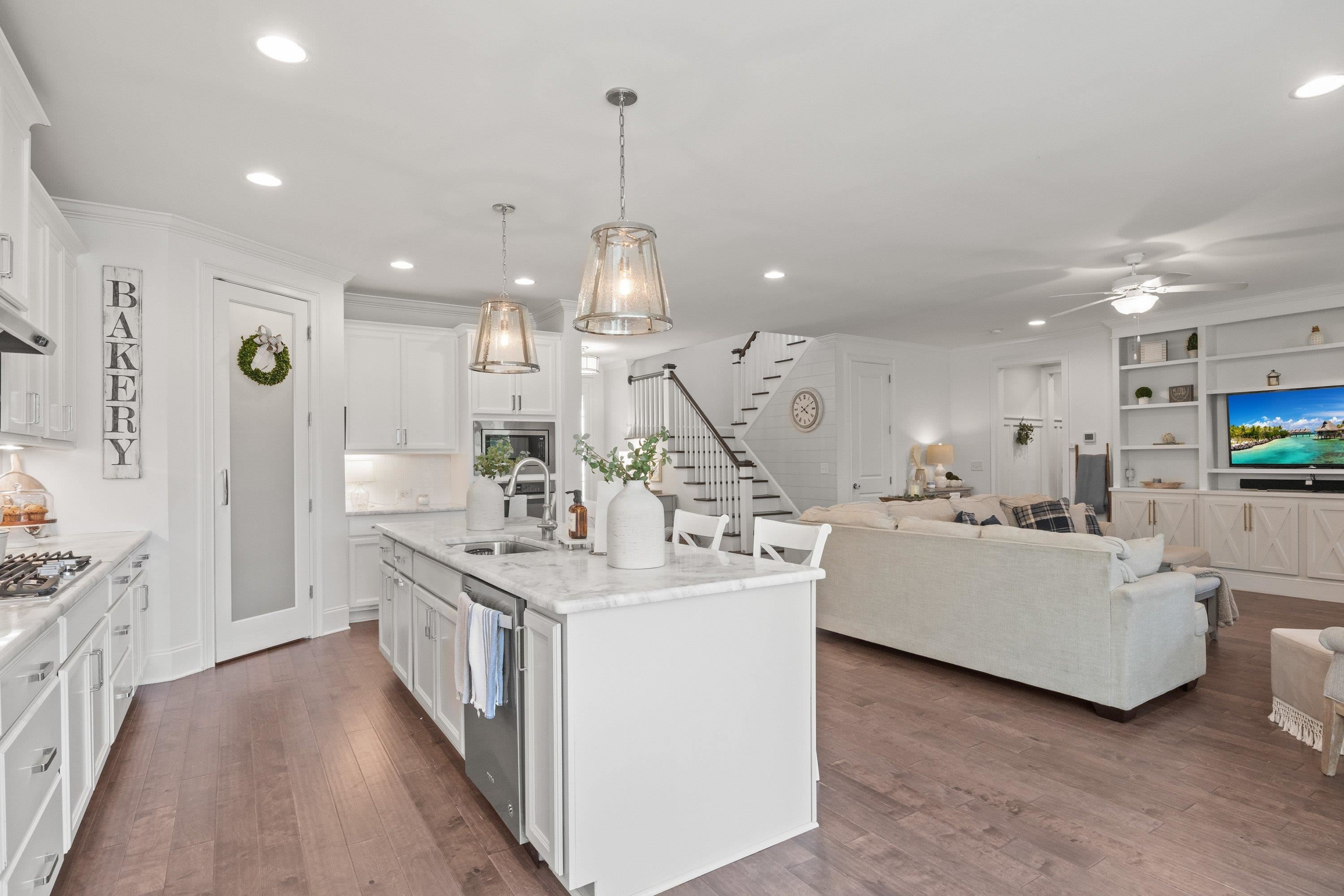4136 Olde Judd Drive Willow Spring, NC 27592 - Photo 13 of 47 a large white kitchen with a large window a sink and stainless steel appliances