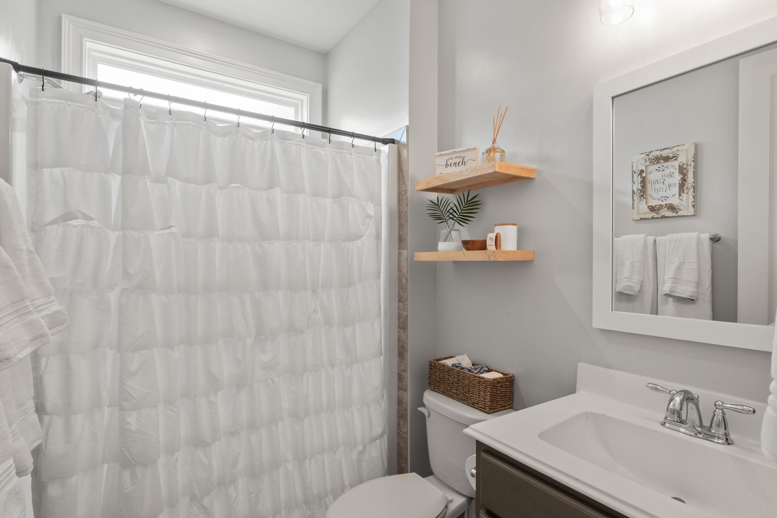 4136 Olde Judd Drive Willow Spring, NC 27592 - Photo 25 of 47 a bathroom with a sink a toilet and shower curtain