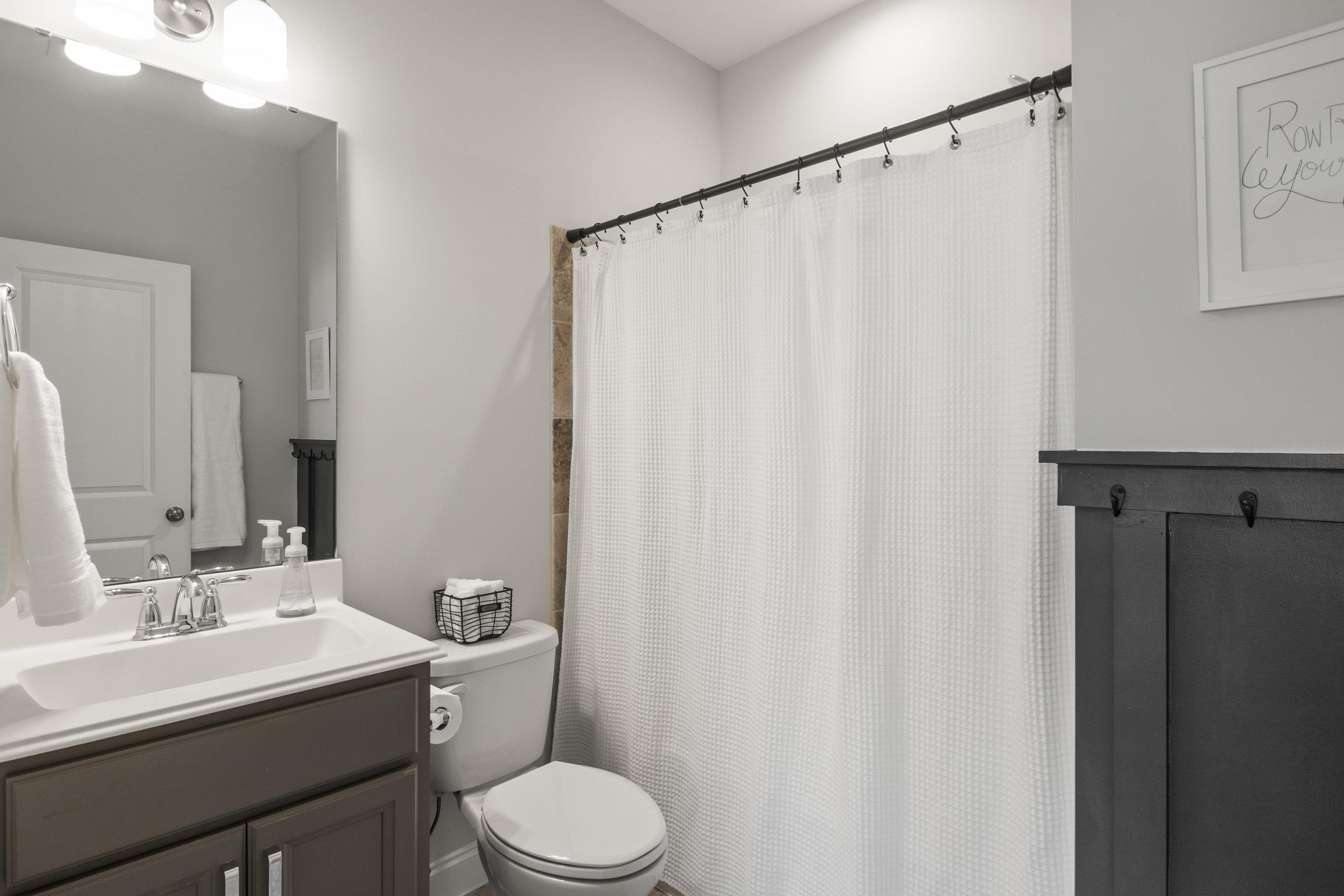 4136 Olde Judd Drive Willow Spring, NC 27592 - Photo 28 of 47 a bathroom with a sink a toilet and shower curtain