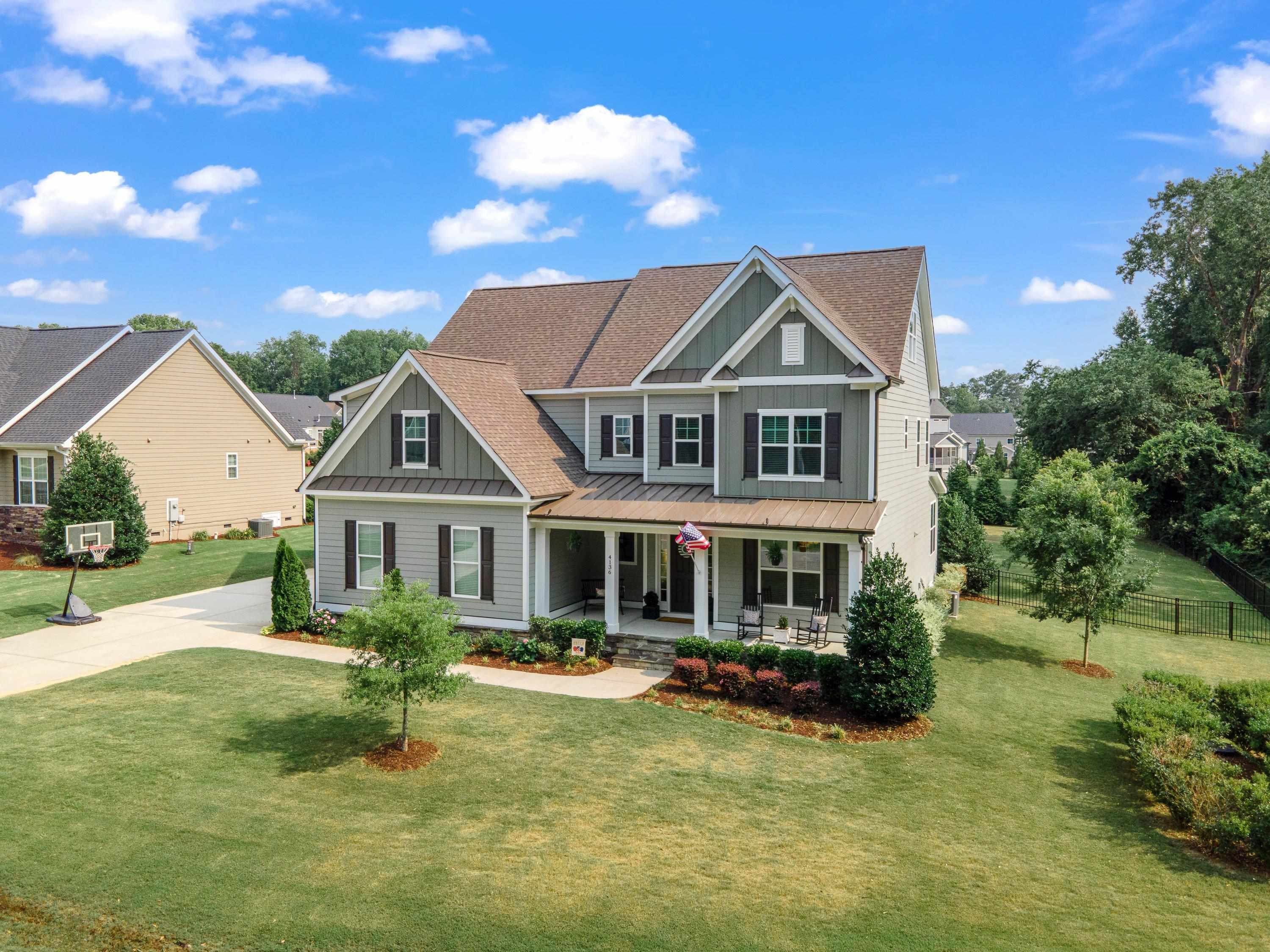 4136 Olde Judd Drive Willow Spring, NC 27592 - Photo 5 of 47 a front view of a house with a yard table and chairs