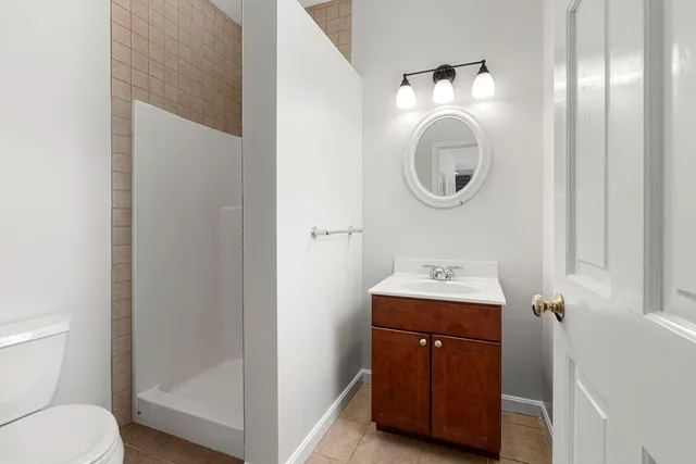 a bathroom with a toilet a sink and a mirror