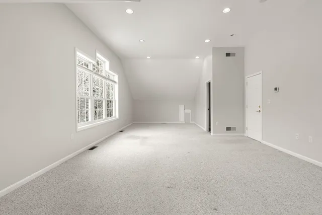 an empty room with windows and closet