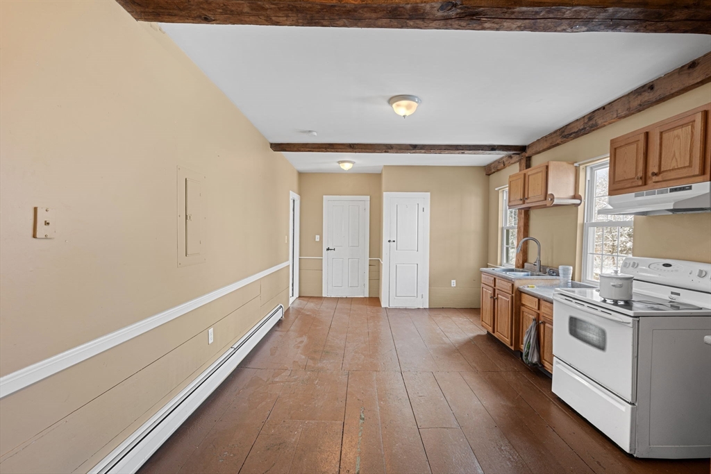 95 Wright Road Hollis, NH 03049 - Photo 33 of 42 a view of a kitchen with a stove wooden floor and a kitchen