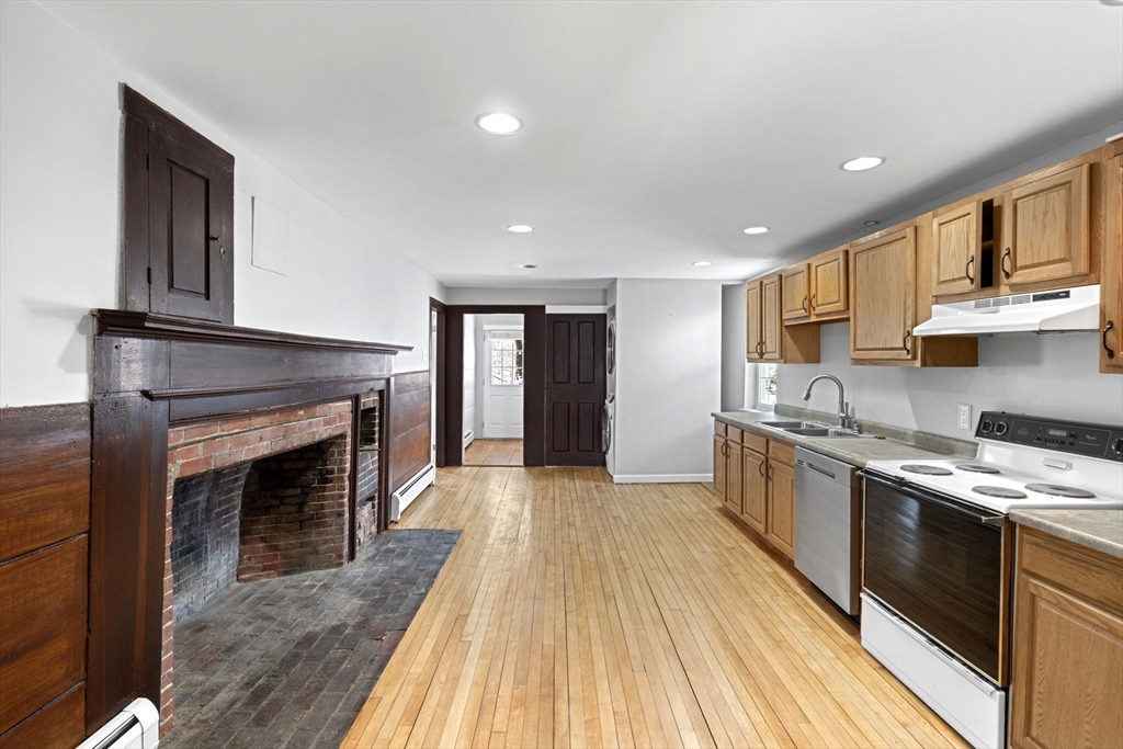 95 Wright Road Hollis, NH 03049 - Photo 37 of 42 a kitchen with stainless steel appliances granite countertop a stove sink and cabinets