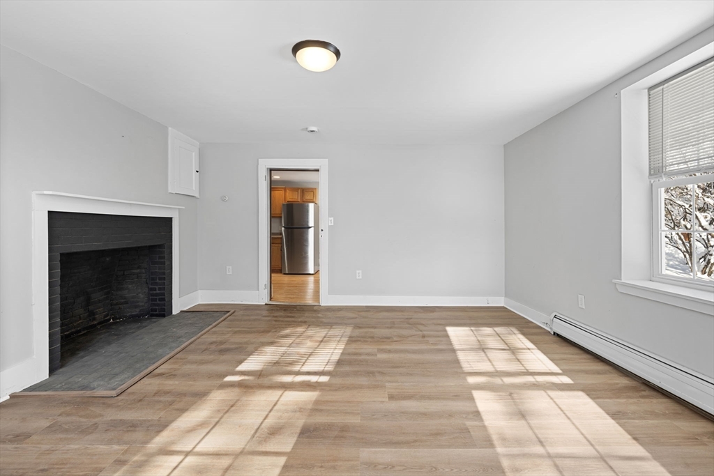 95 Wright Road Hollis, NH 03049 - Photo 38 of 42 a view of empty room with windows and fireplace