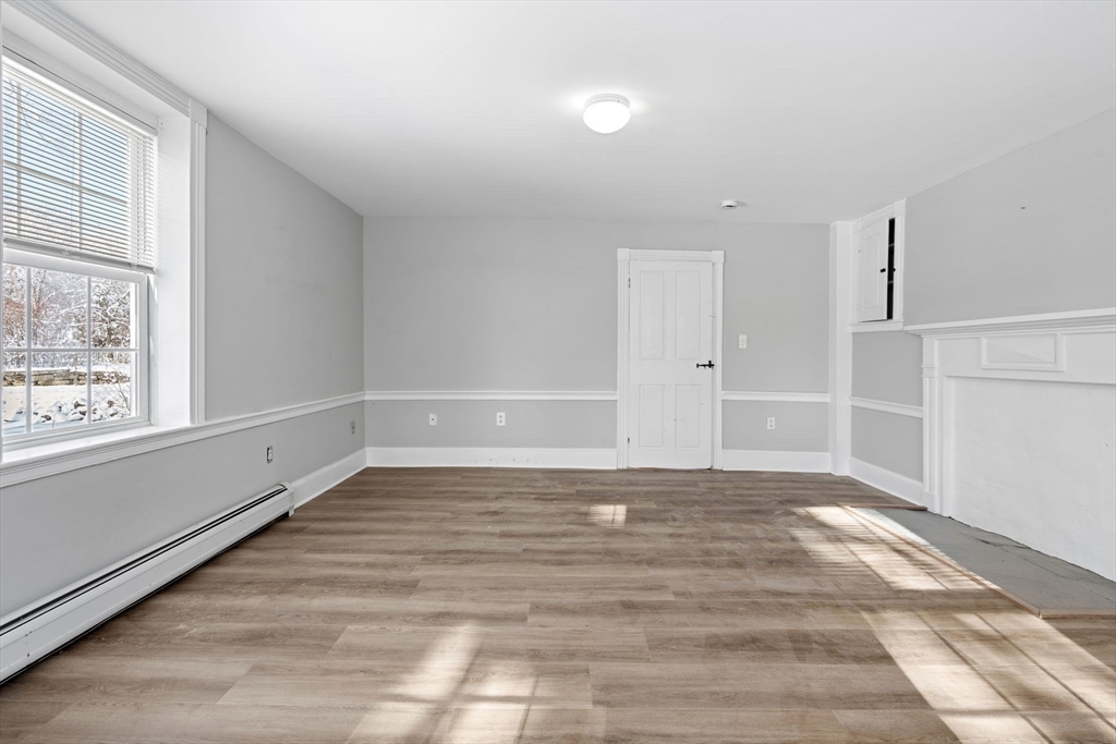 95 Wright Road Hollis, NH 03049 - Photo 40 of 42 a view of an empty room with wooden floor and a window