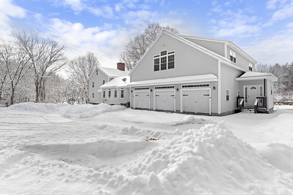 95 Wright Road Hollis, NH 03049 - Photo 42 of 42 a view of a white house with a snow on the road