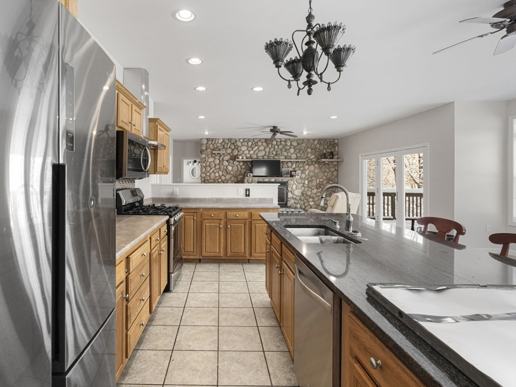 95 Wright Road Hollis, NH 03049 - Photo 7 of 42 a kitchen with stainless steel appliances granite countertop a sink a stove and a refrigerator