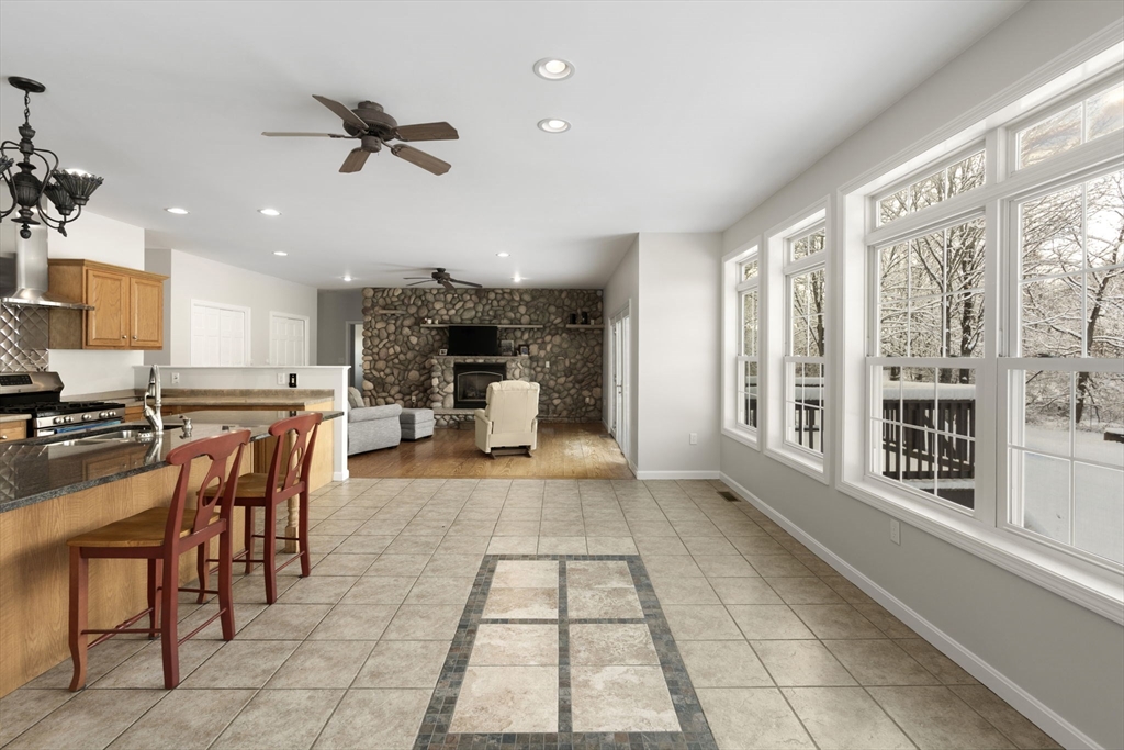 95 Wright Road Hollis, NH 03049 - Photo 10 of 42 a dining hall with stainless steel appliances granite countertop a table and chairs