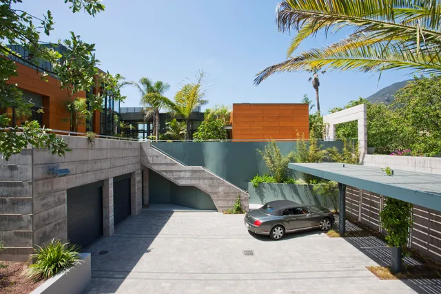 a roof deck with table and chairs potted plants