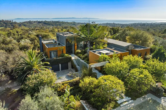 an aerial view of a house with a ocean view