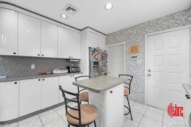 a kitchen with stainless steel appliances granite countertop a sink and cabinets