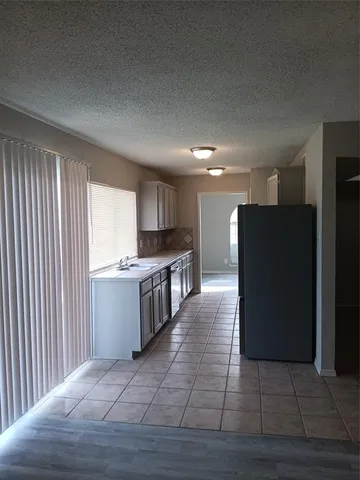 a large space with kitchen view and a window