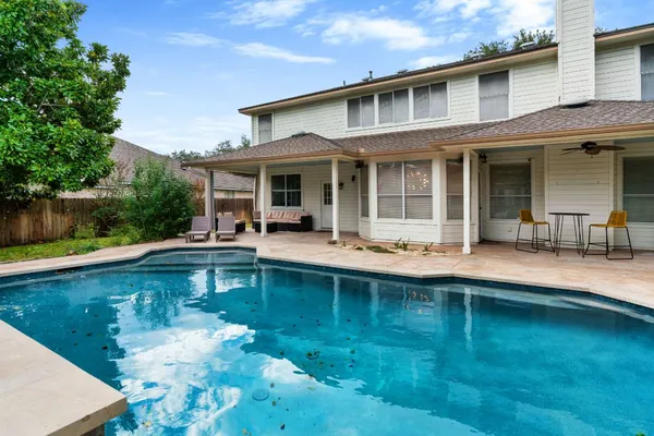 a view of a house with swimming pool and porch